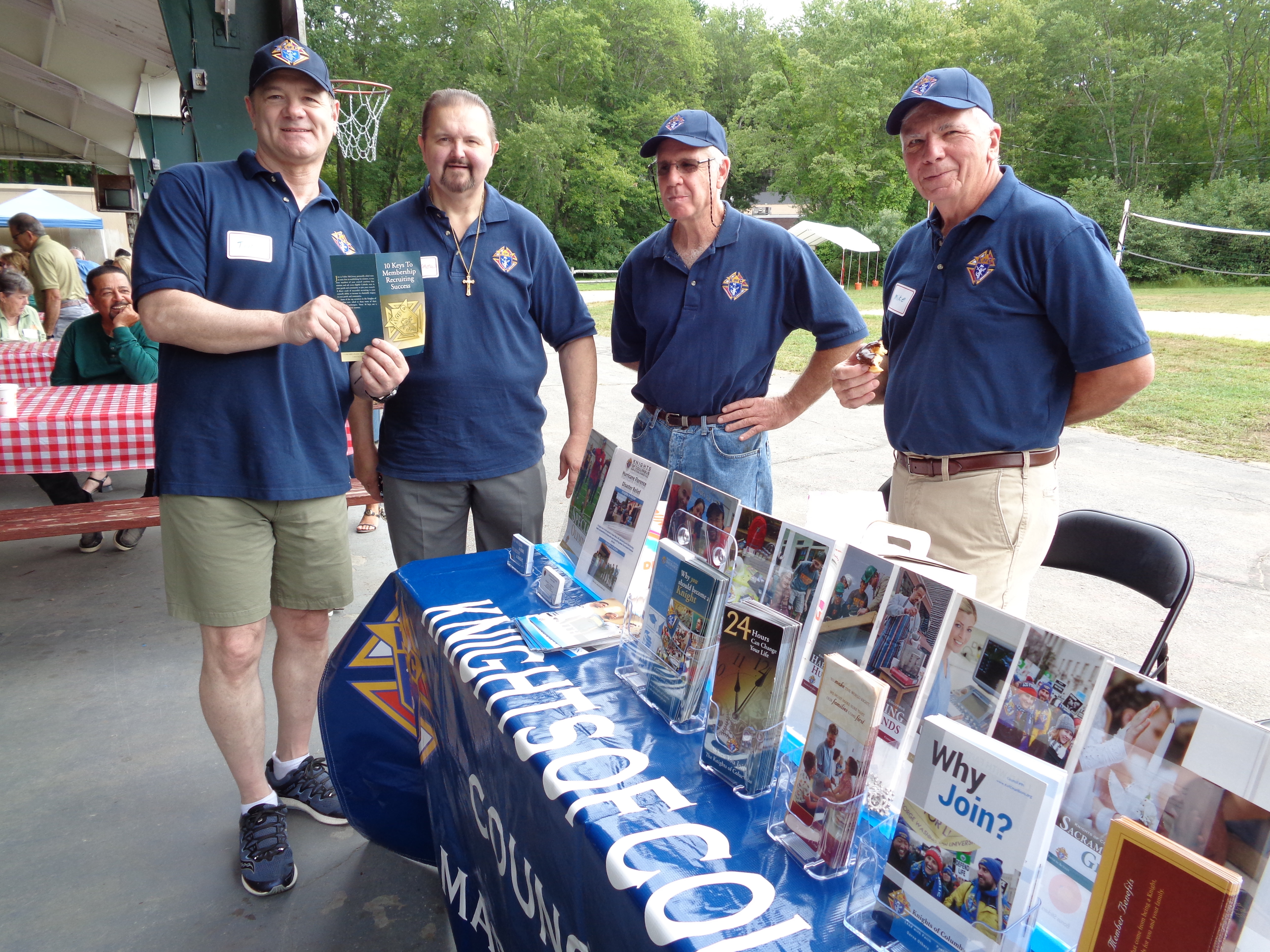 Tim Guttner, Andy Tivnan, Mike Cahill and Mike Wells staffing the KofC Table at the Ministry Exposition